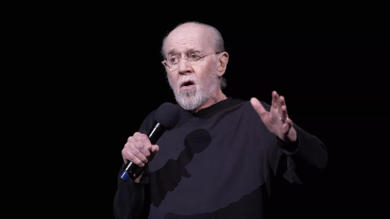 Unmasked with George Carlin backdrop