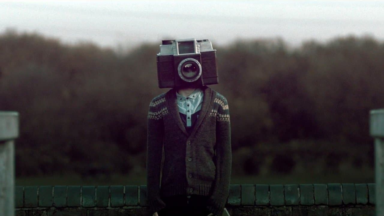 The Boy with a Camera for a Face backdrop